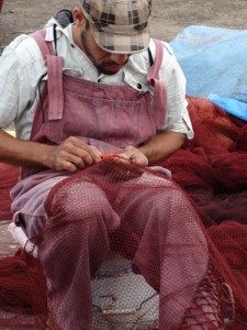 Essaouira fisherman mending his nets