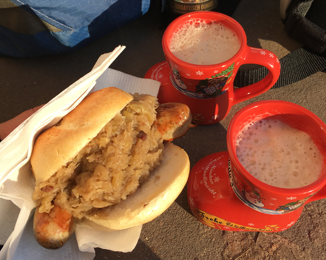 Delicious wurst, sauerkraut and the extra bottle of monk-brewed beer from Schonegger cheese farm, thoroughly enjoyed in the sunshine while people watching outside the quaint Christmas Market