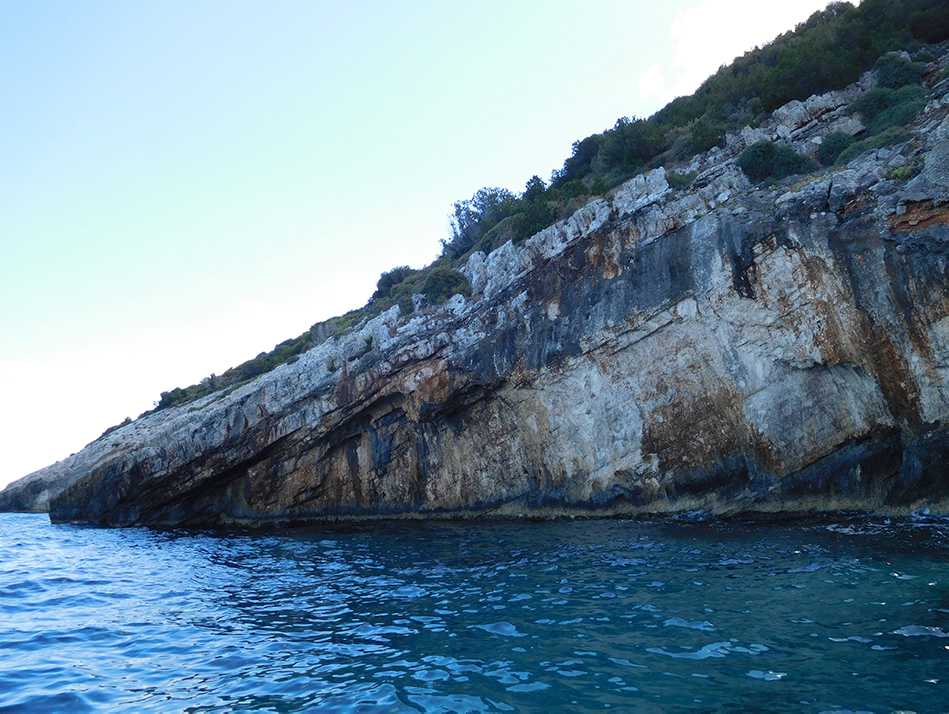 The interesting geology makes the cliffs appear to spear into the water near the Blue Cave on northern Zante